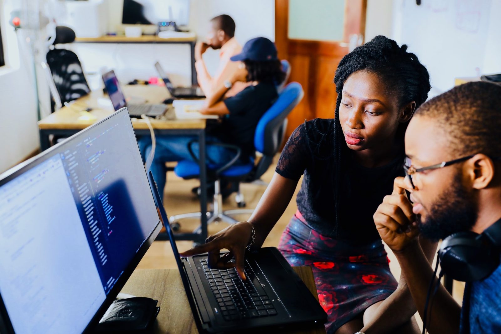 Colleagues working together at a computer screen